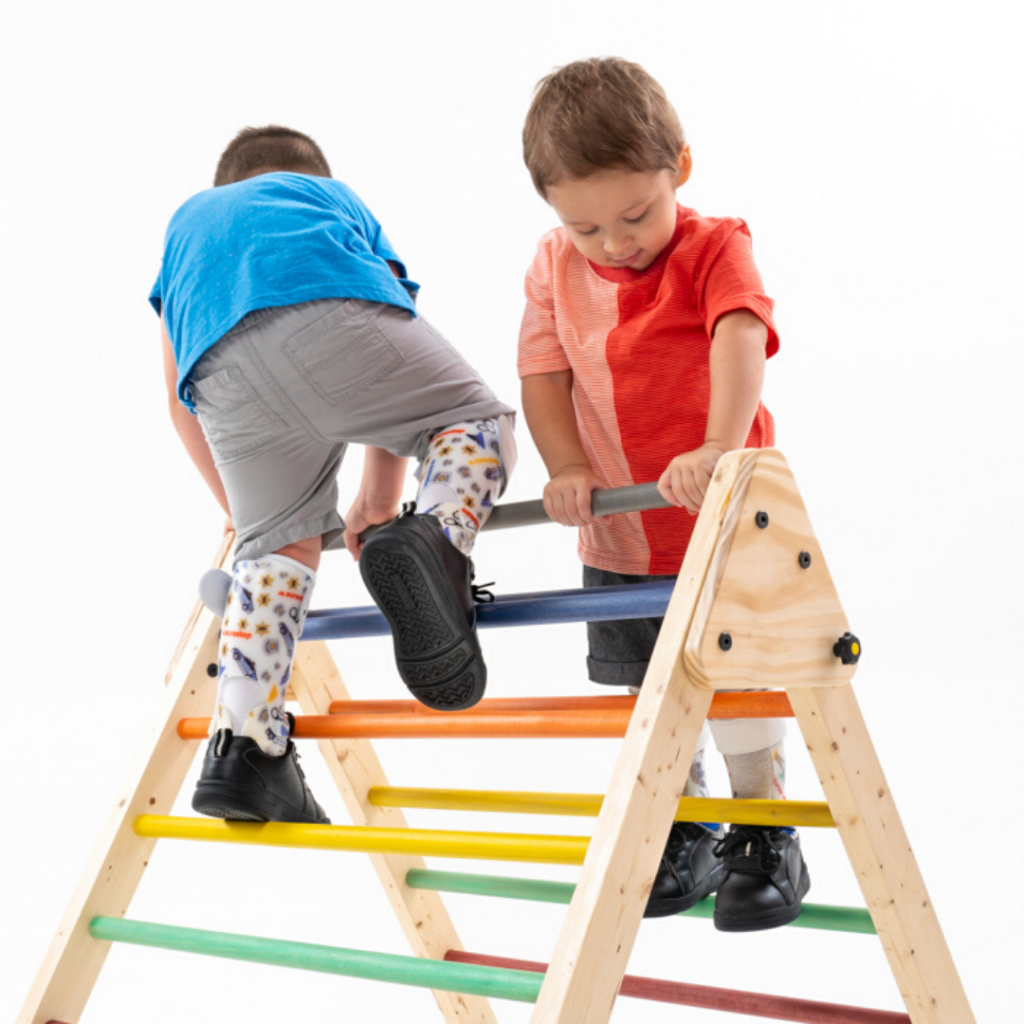 Two kids who are wearing AFOs are playing together