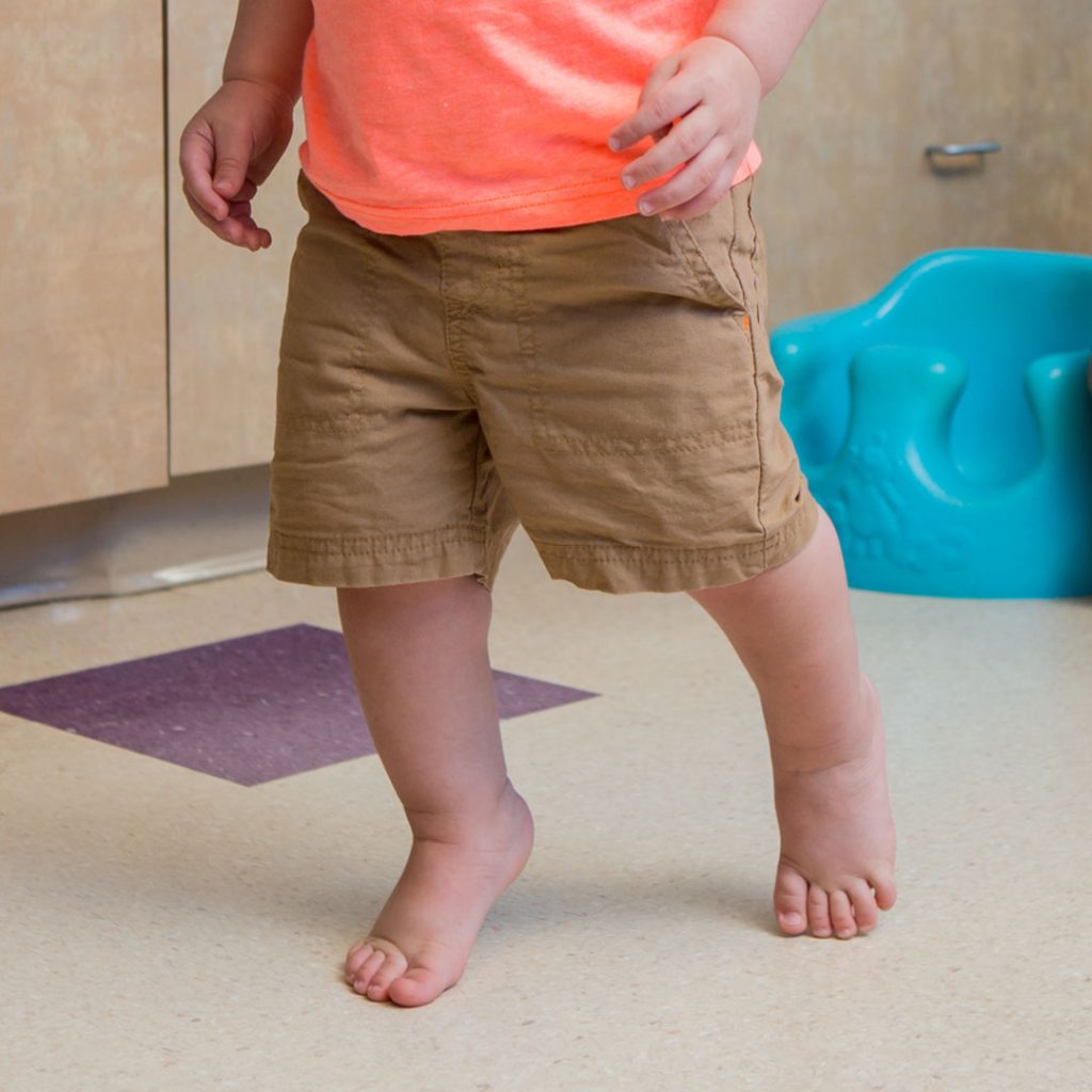 Baby learning to walk on sale tiptoes